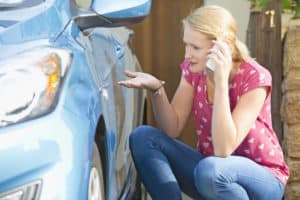 woman calling the car insurance company after an accident