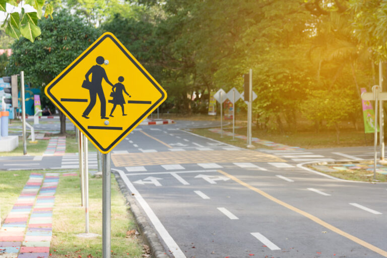 Students,Crossing,Ahead,Sign